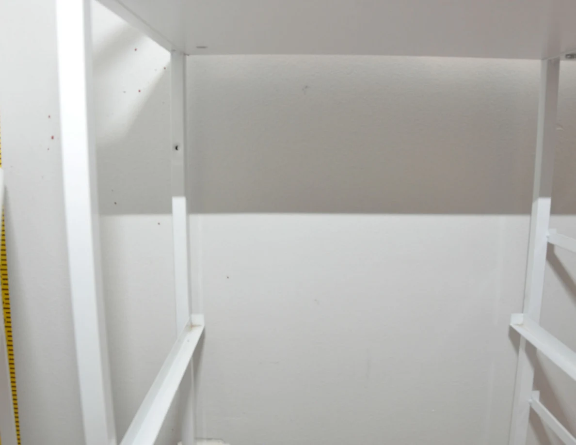 White cabinet frame against a pale wall.