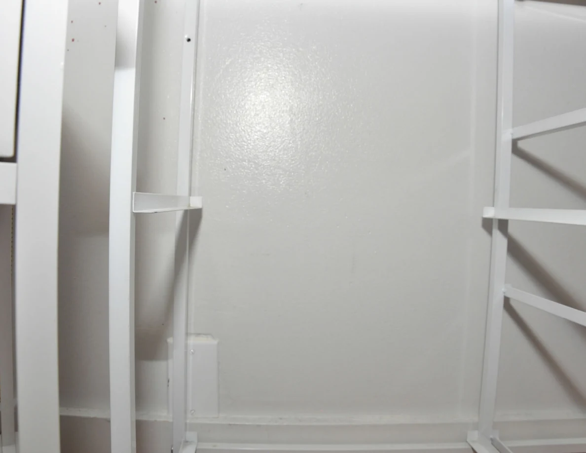 White cabinet frame against a pale wall.