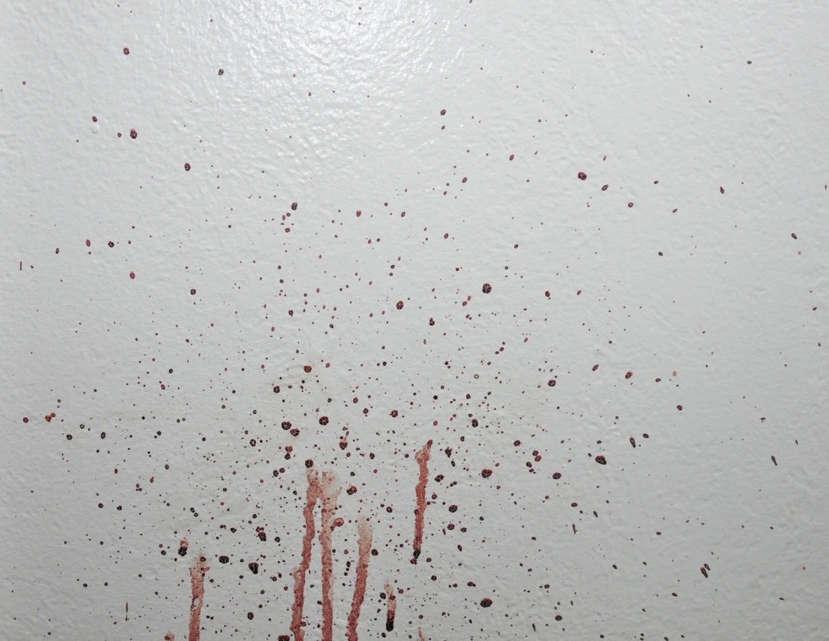 Reddish wall spots and vertical streaks.