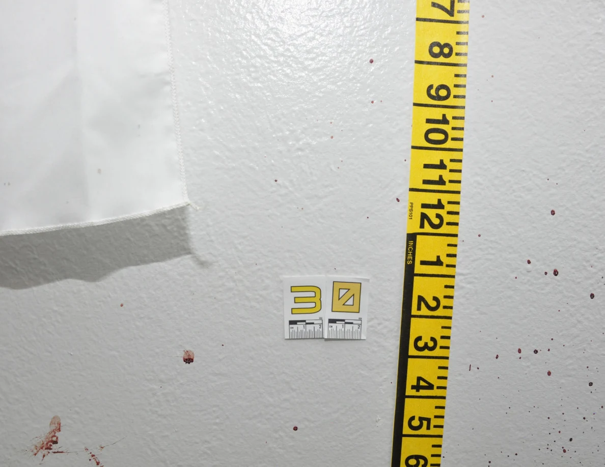 Scale label 30 and measuring tape beside reddish wall spots.
