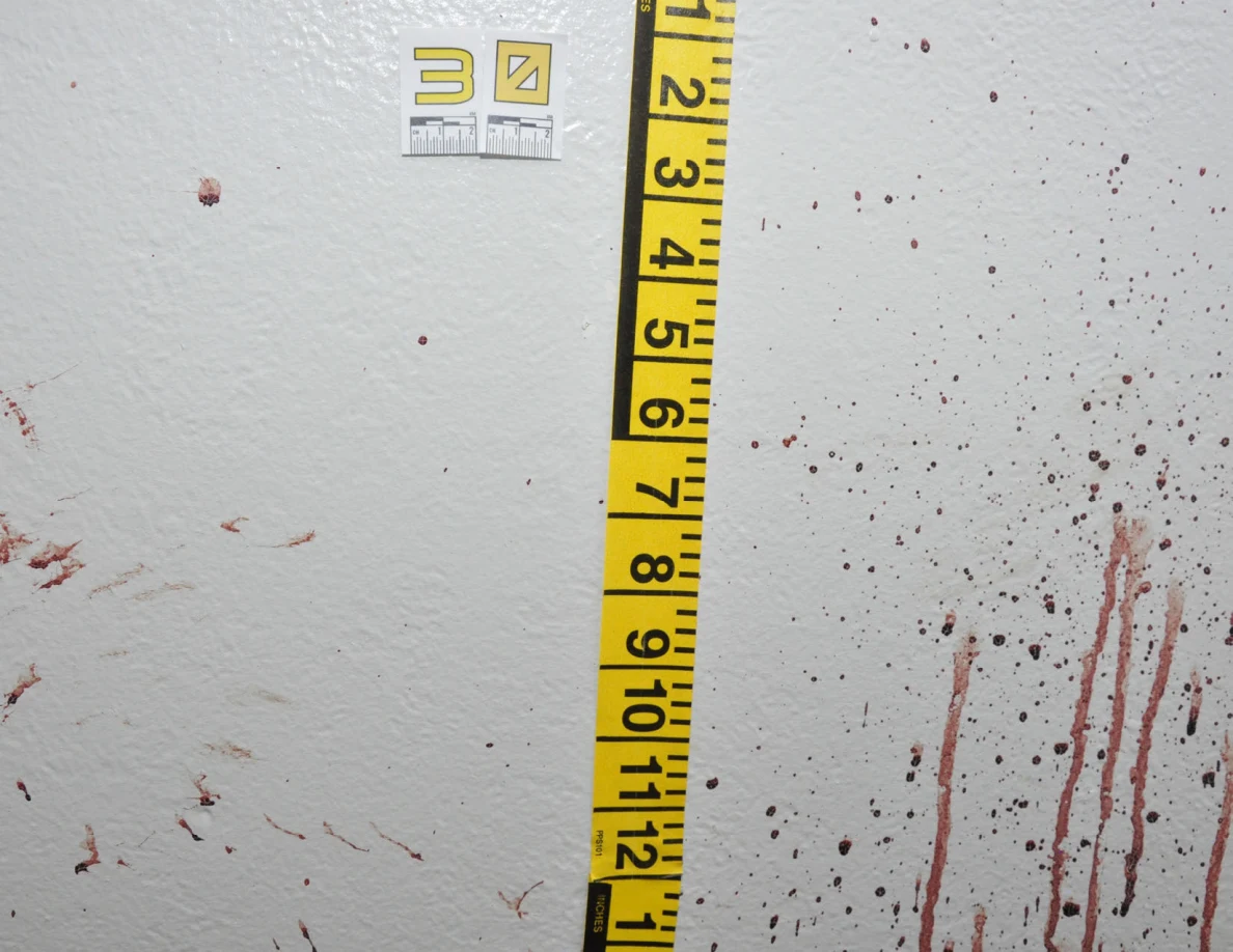 Reddish spots and streaks beside scale label 30 and measuring tape.