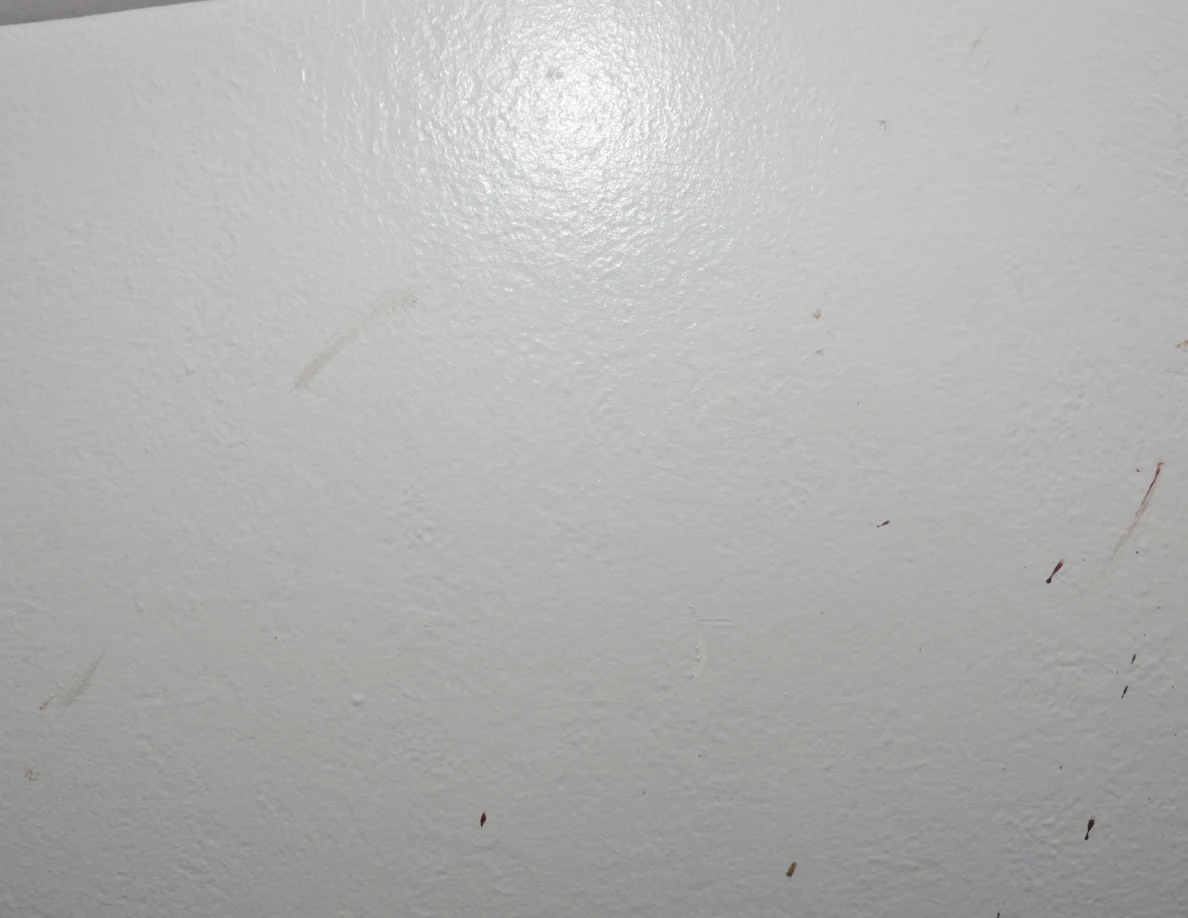Faint streaks on a pale wall.