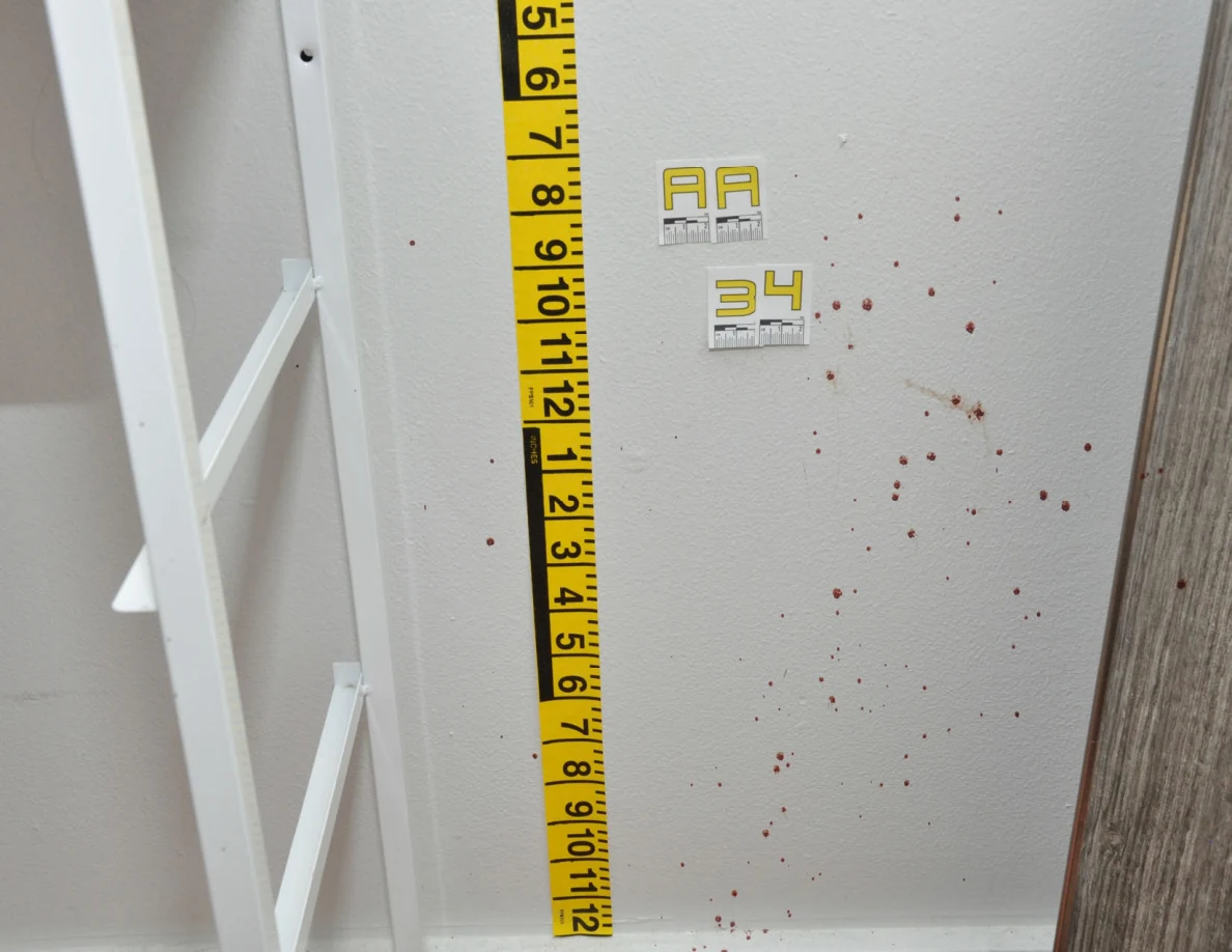 Reddish wall spots beside label AA34, measuring tape and a cabinet mirror.