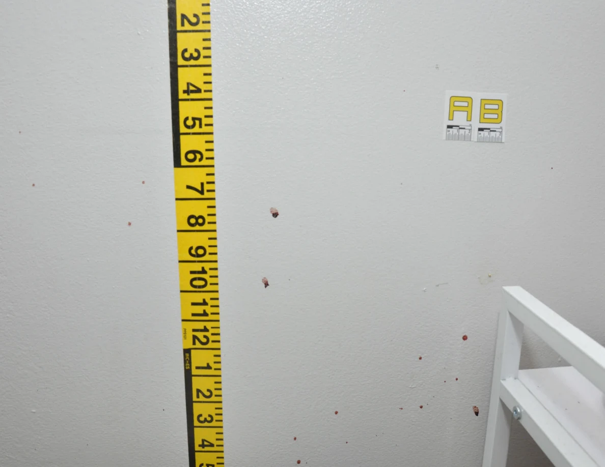 Wall label AB and measuring tape beside a cabinet edge.