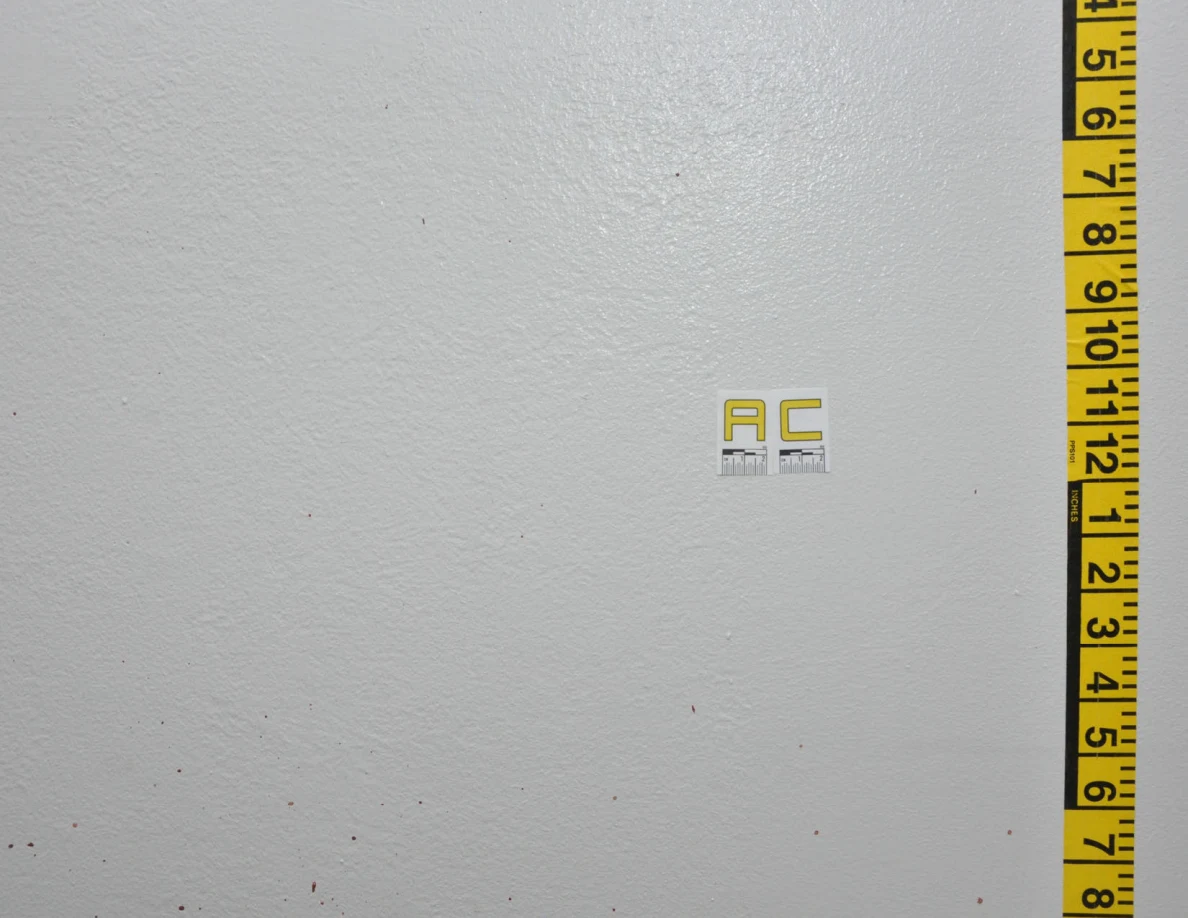 Faint wall spots beside label AC and vertical measuring tape.