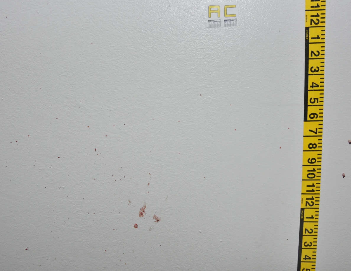 Reddish wall spots beside label AC and vertical measuring tape.