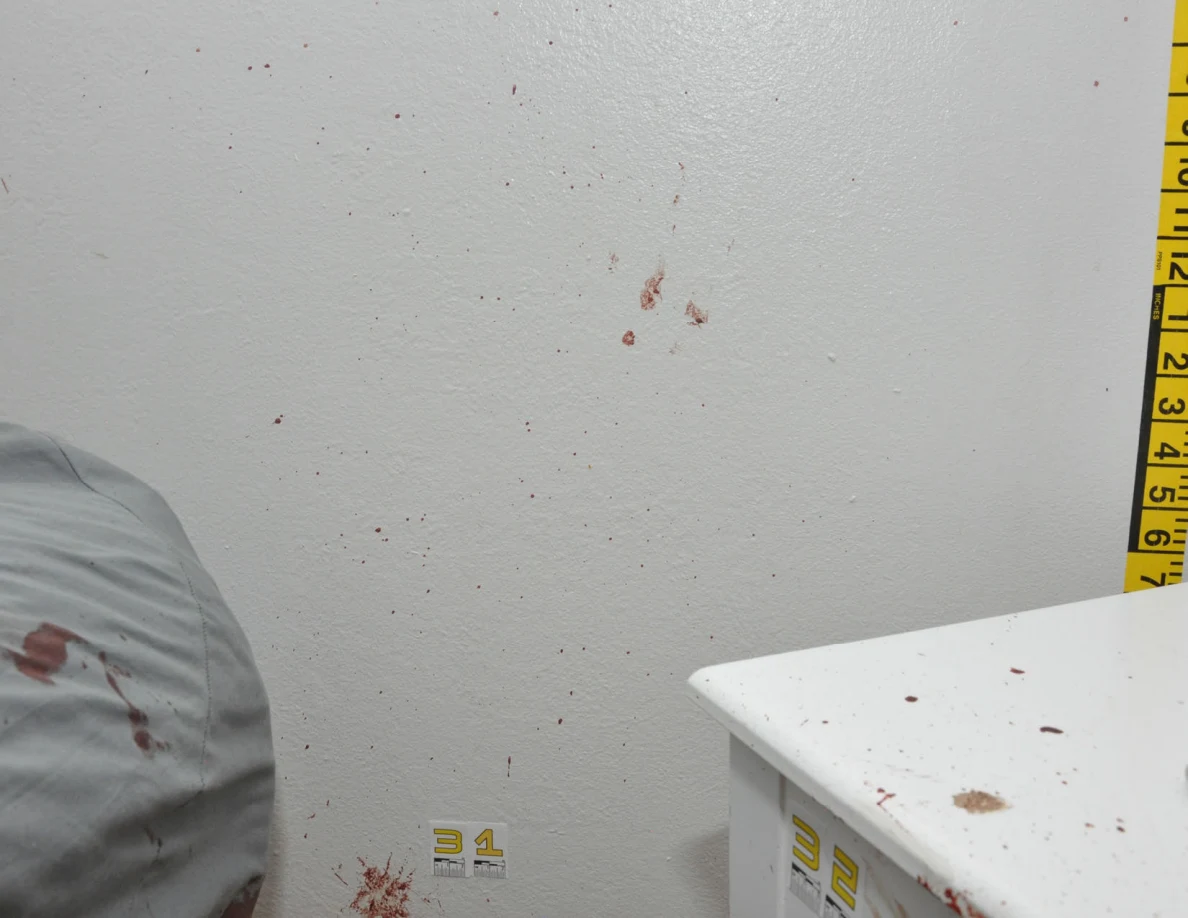 Wall spots above label 31 between a bed and a white cabinet, with measuring tape.