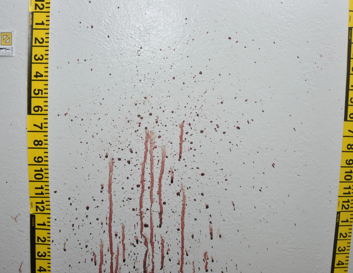 Reddish wall spots and long vertical streaks between yellow measuring tapes.