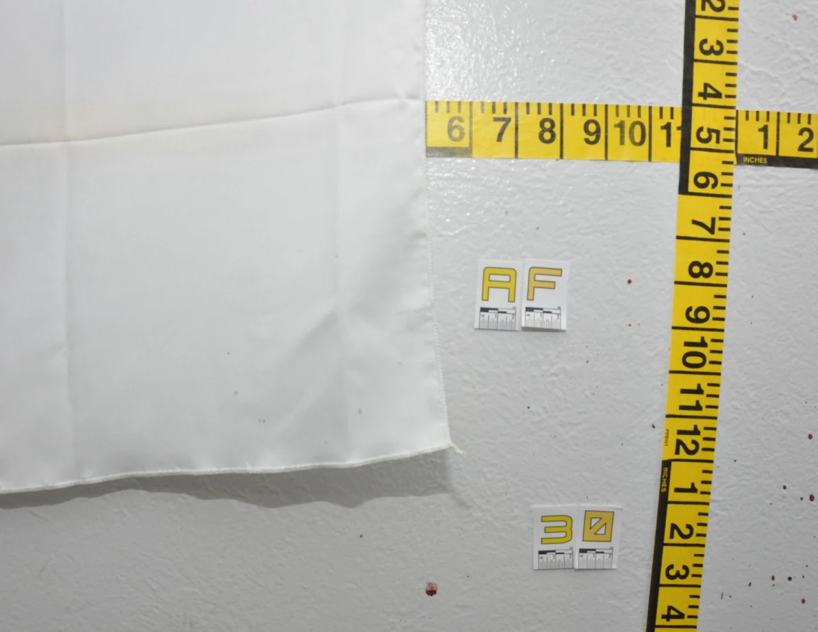 Fabric hanging edge beside labels AF and 30 and crossed measuring tapes.