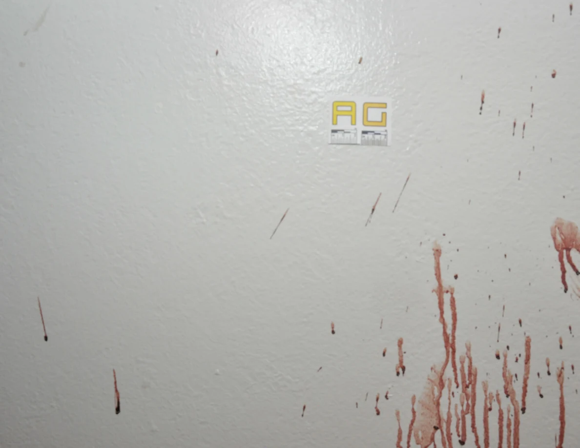 Reddish wall streaks and spots beside label AG.