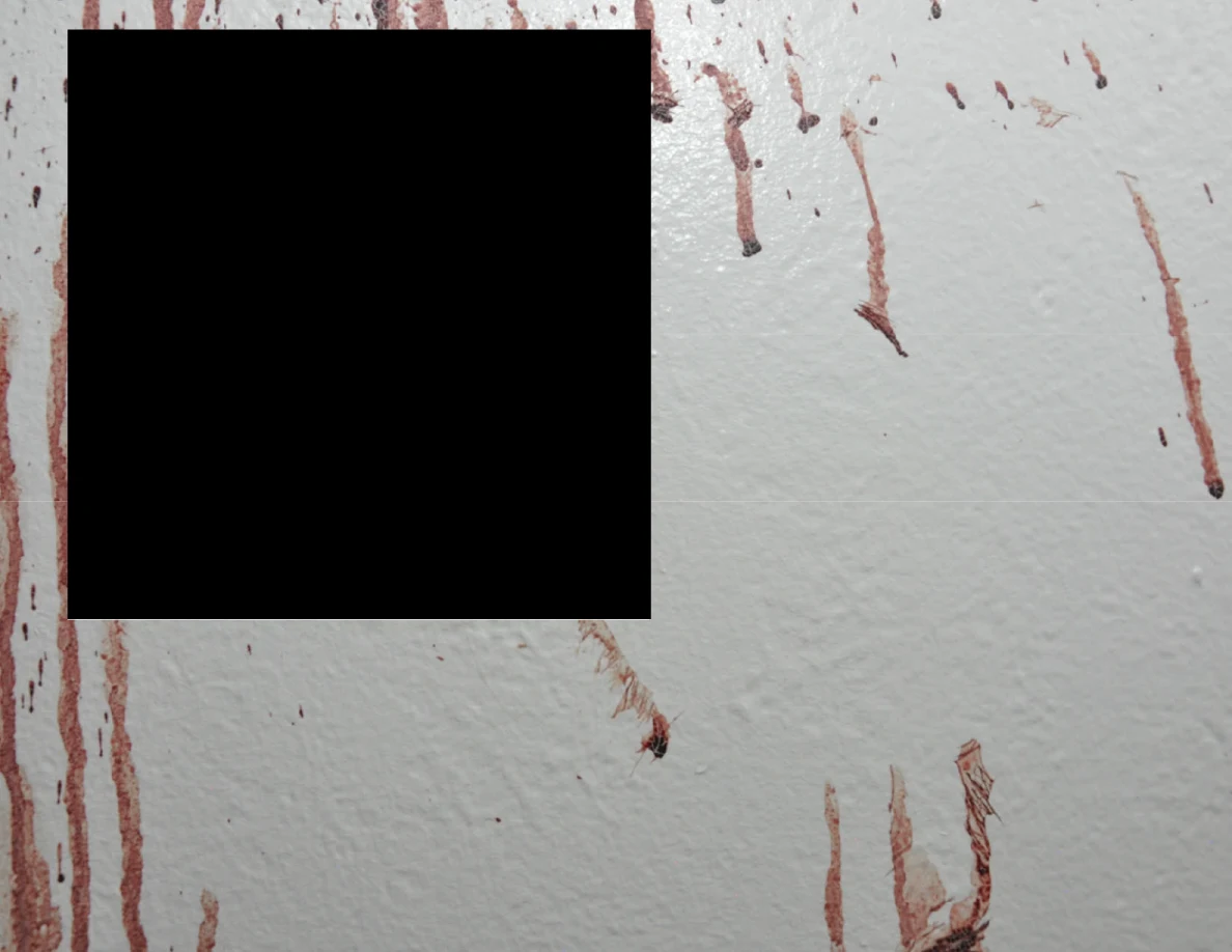 Reddish wall streaks beside and below a black redaction.
